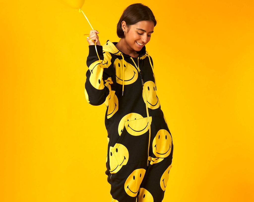 Woman wearing black onesie with Smiley print