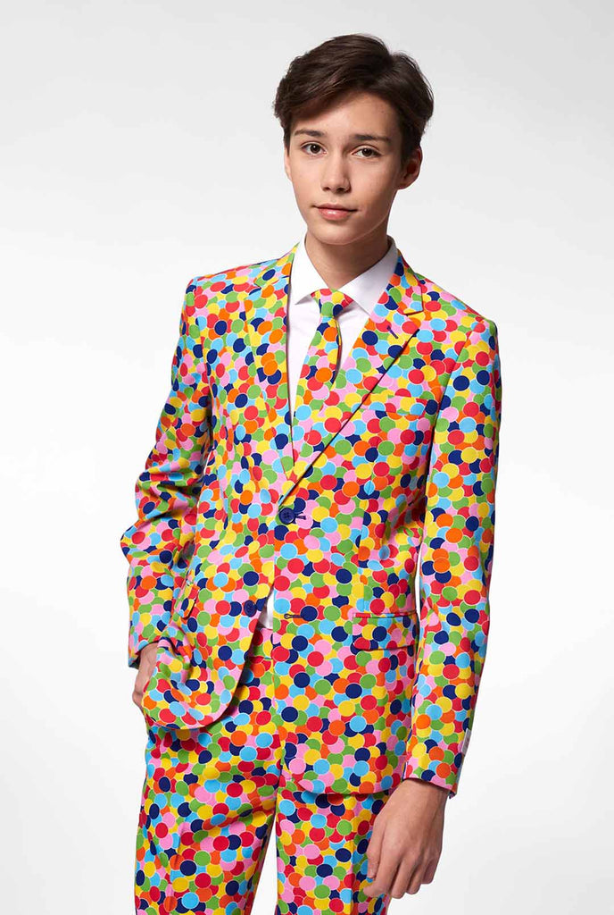 Teen wearing formal suit with confetti print
