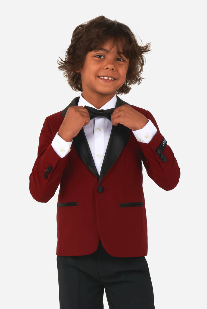 Kid wearing red and black tuxedo