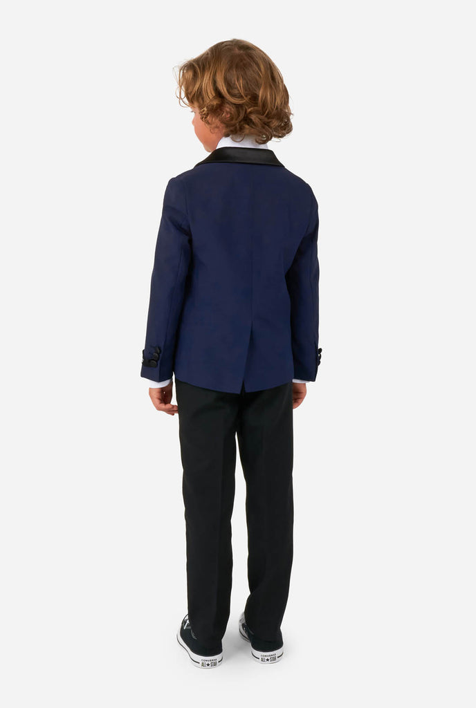 Kid wearing blue and black tuxedo, view from the back
