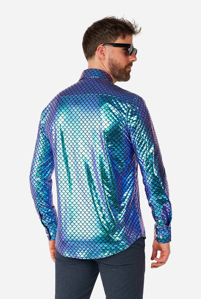 Man wearing blue fishscale print shirt, view from the back