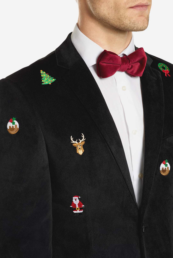 Man wearing black Christmas blazer with Christmas icons, close up
