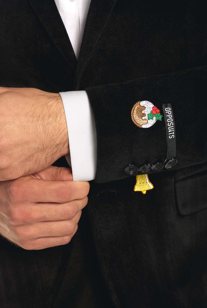 Man wearing black Christmas blazer with Christmas icons, close up