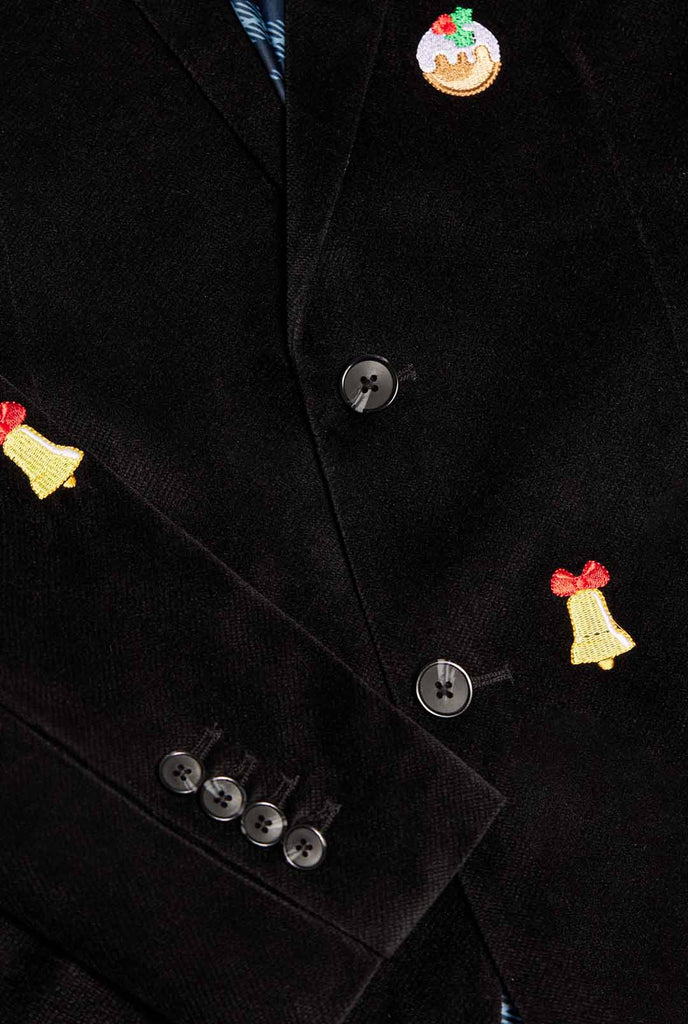 Man wearing black Christmas blazer with Christmas icons,  close up