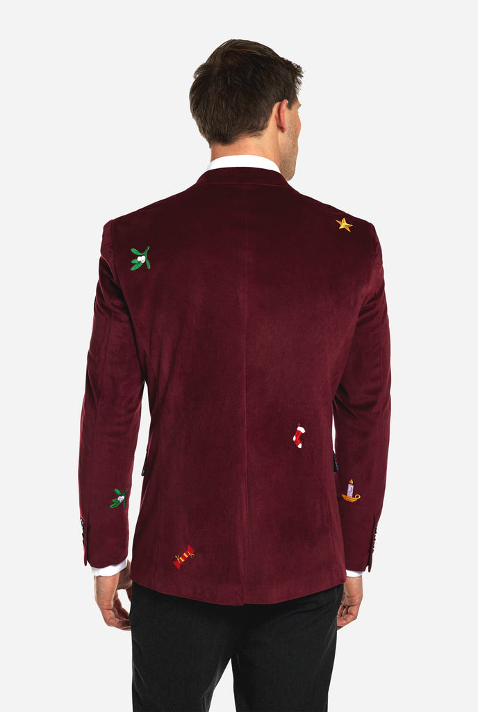 Man wearing burgundy red velvet Christmas blazer with Christmas icons, view from the back
