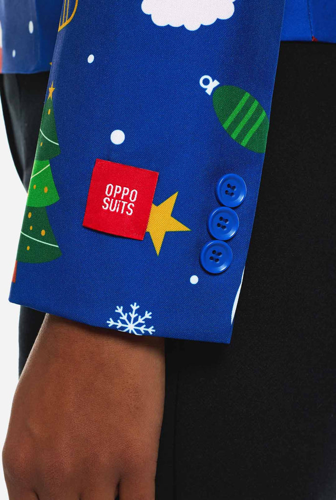Woman wearing blue Christmas blazer for women, with Christmas icons on it. Sleeve close up.