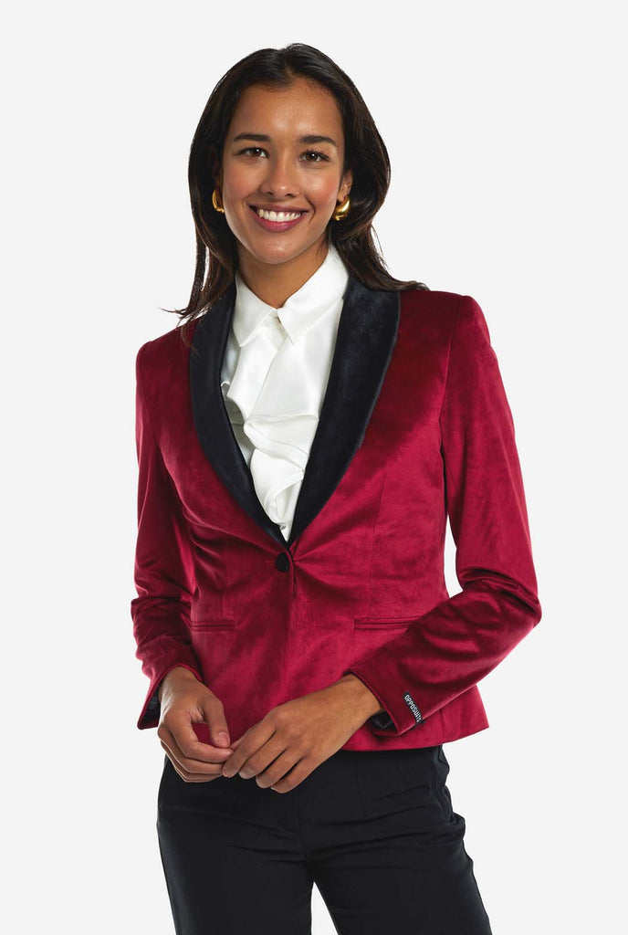 Woman wearing burgundy red velvet dinner jacket blazer