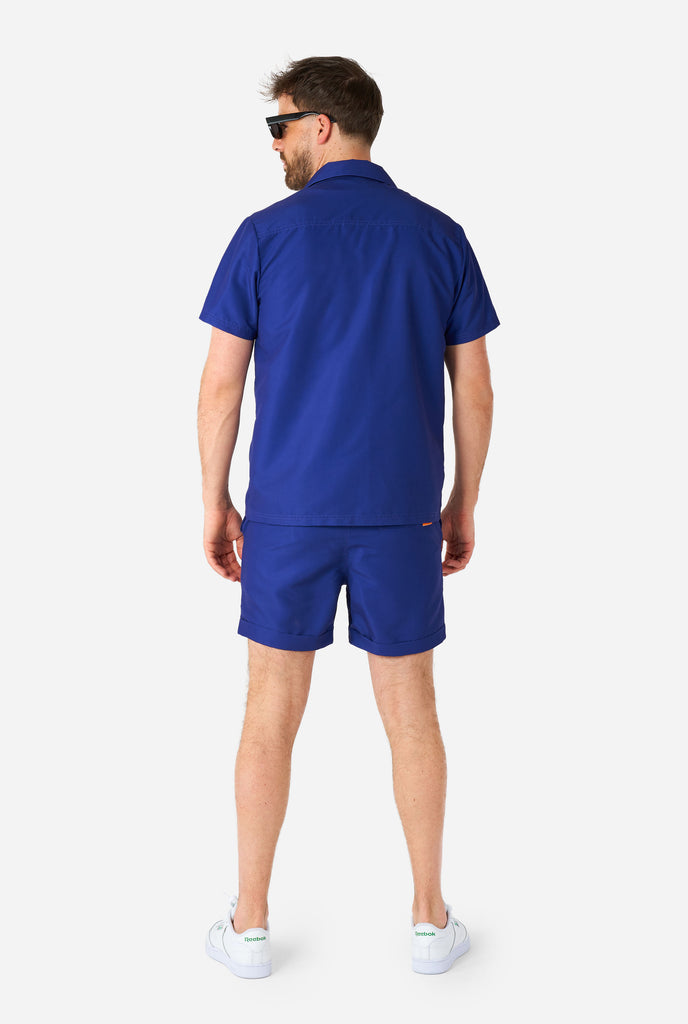 Man wearing bleu summer set consisting of shirt and shorts