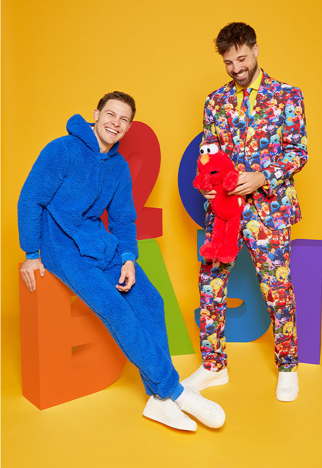 2 men wearing Sesame street outfit, 1 a Cookie Monster onesie and 1 a Sesame street suit