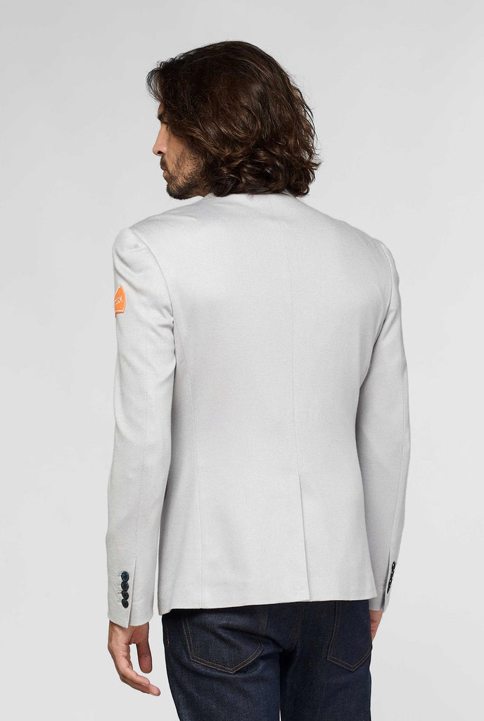 Grey sportswear casual blazer with sports patches worn by man