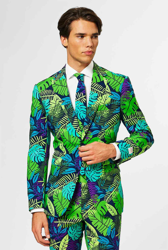Jungle print men's suit with green and purple leaf print worn by man
