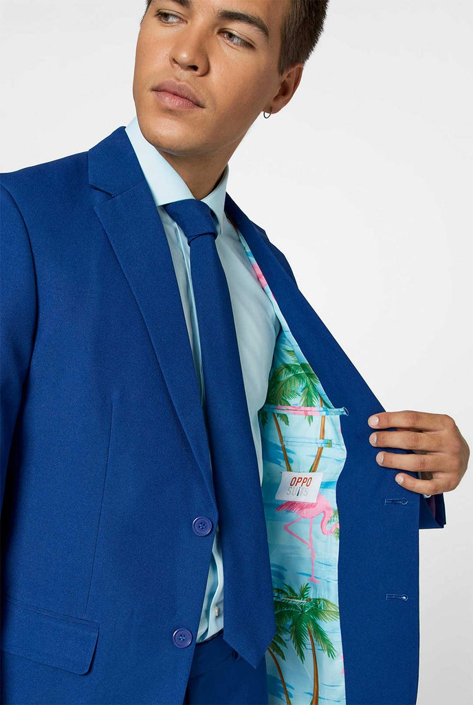 Close up dark blue men's suit with multicolor lining with flamingos worn by man