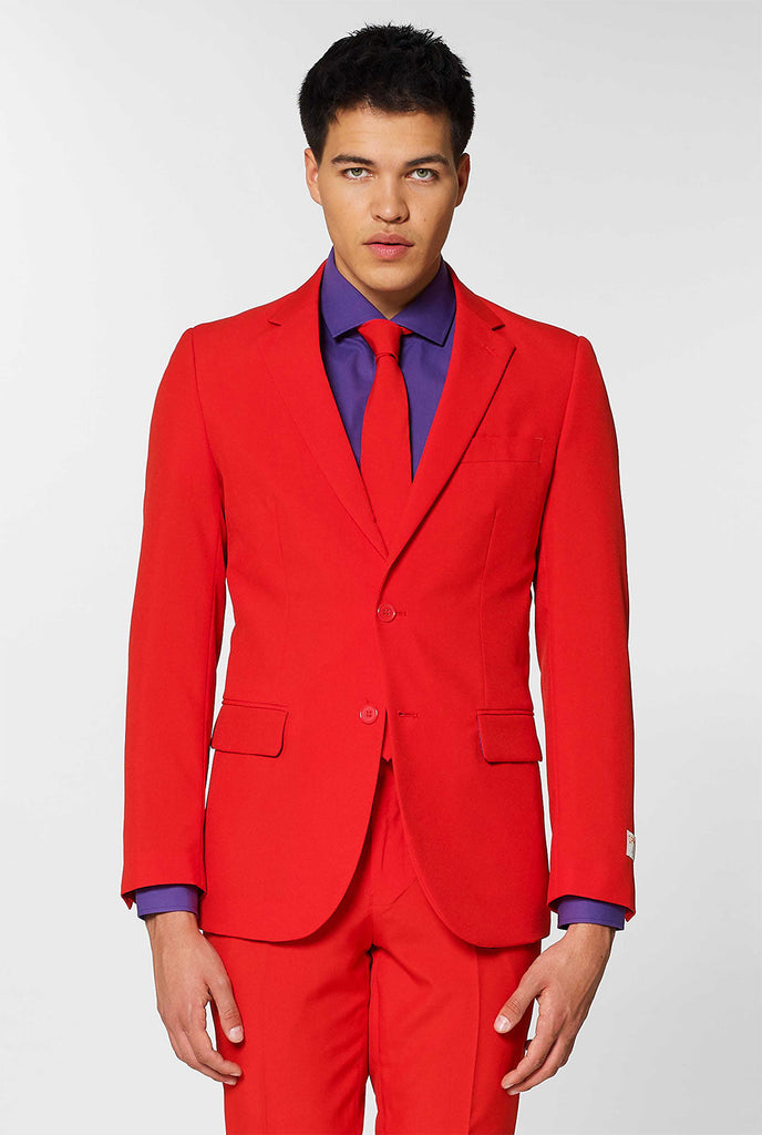 Man wearing red men's suit with purple dress shirt 