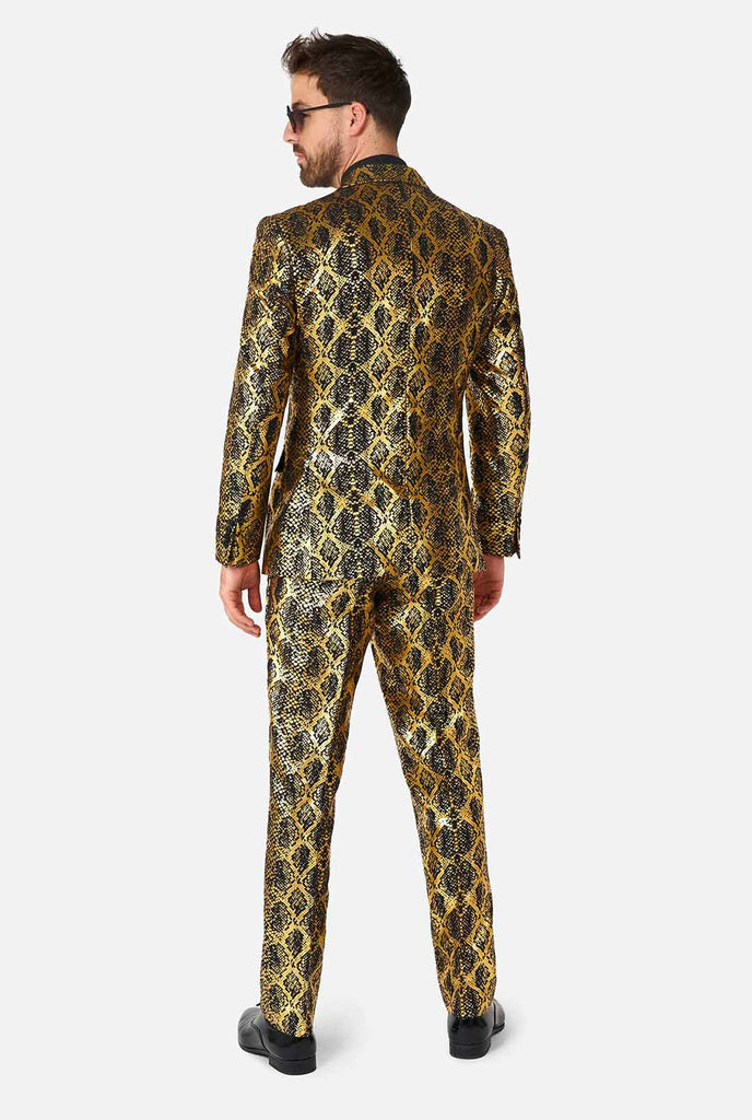 Man wearing suit with, gold and black, snakeskin print