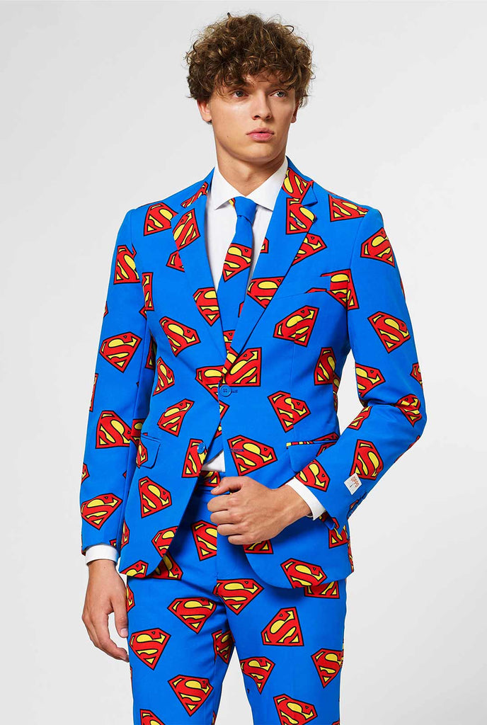 Man wearing blue men's suit with Superman logo print