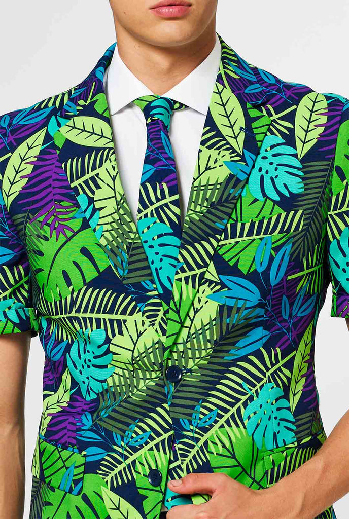 Man wearing green summer suit with jungle leaf print