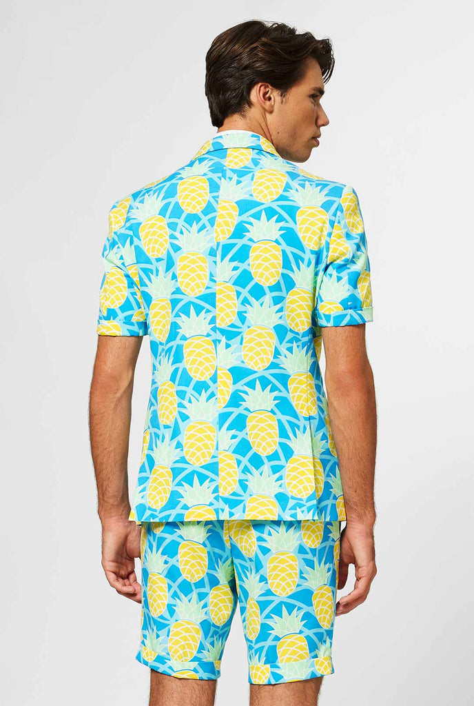 Man wearing blue summer suit with pineapple print
