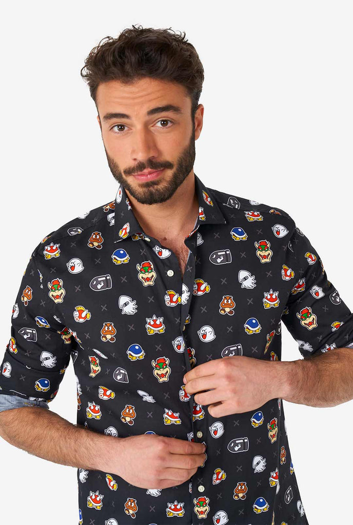 Man wearing black dress shirt with Super Mario bad guys icons