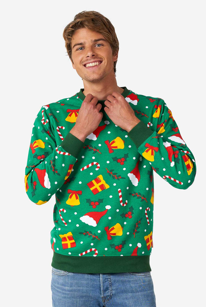 Man wearing green Christmas sweater with Christmas icons