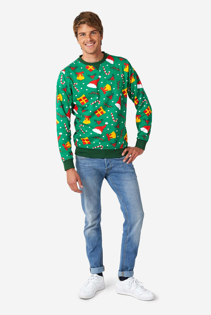 Man wearing green Christmas sweater with Christmas icons