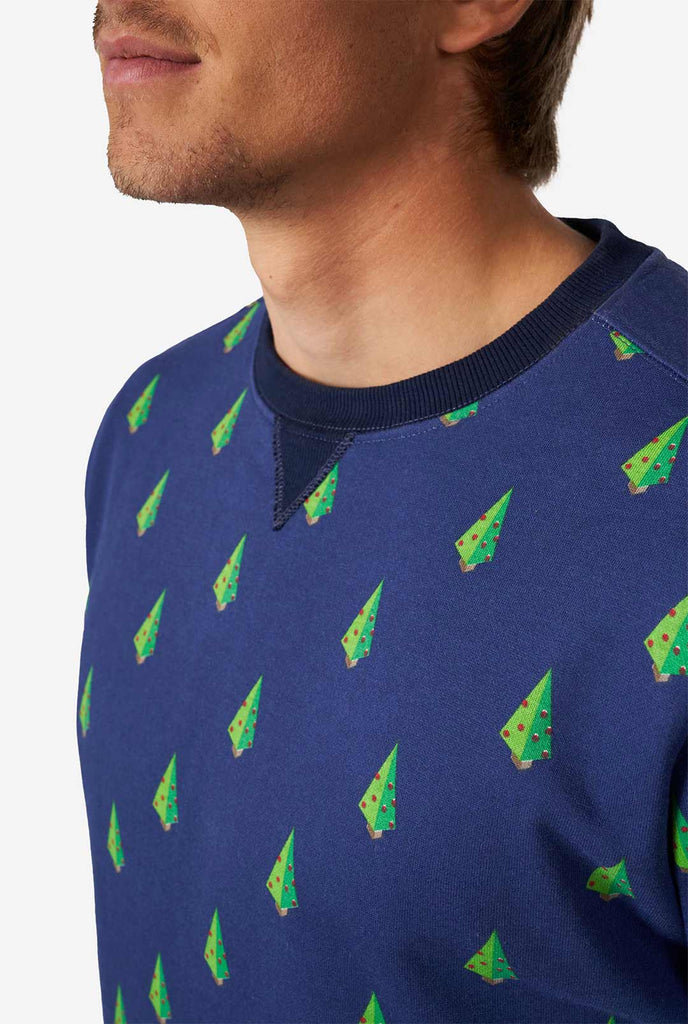 Man wearing blue Christmas sweater with Christmas tree print