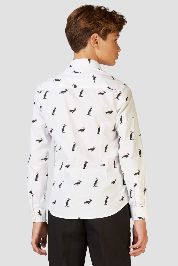 White Christmas dress shirt with Christmas penguins worn by a teen boy zoomed in