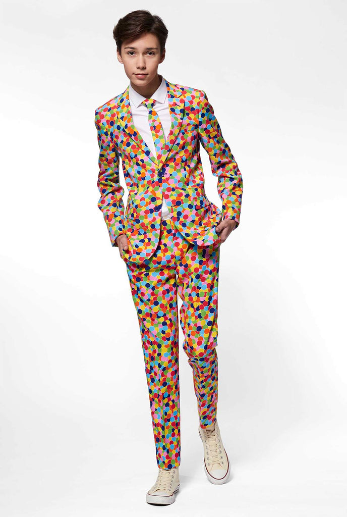 Teen wearing formal suit with confetti print