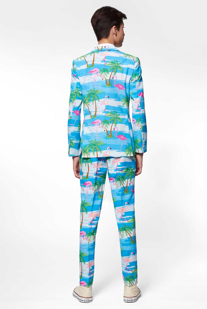 Teen wearing light blue suit with flamingo palm tree print