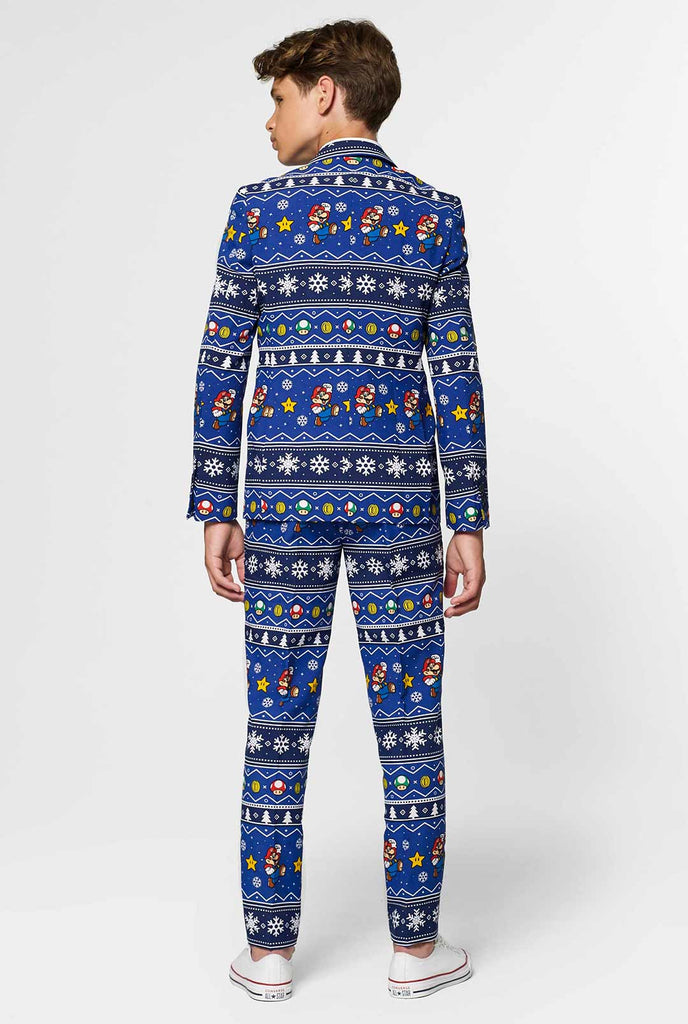 Teen wearing blue Christmas suit with Super Mario print
