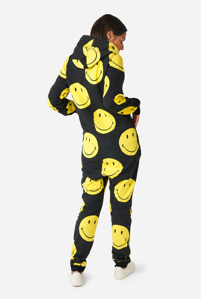 Man wearing black onesie with yellow smiley print