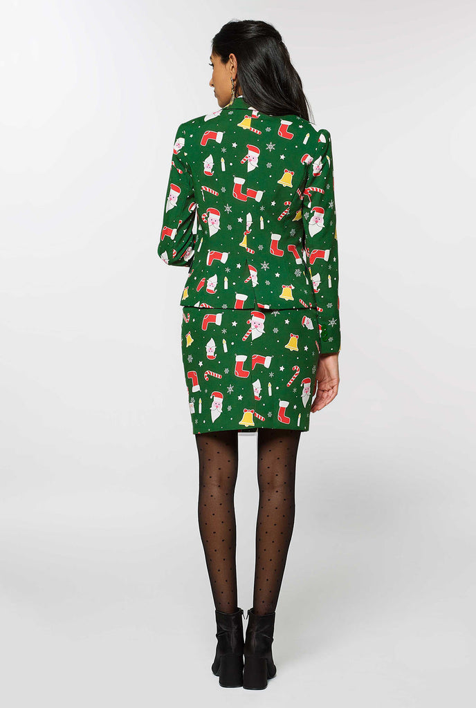 Woman wearing green suit with Christmas icons