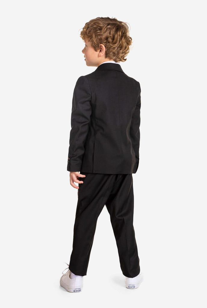 Boy wearing black OppoSuits Daily kids suit, view from the back