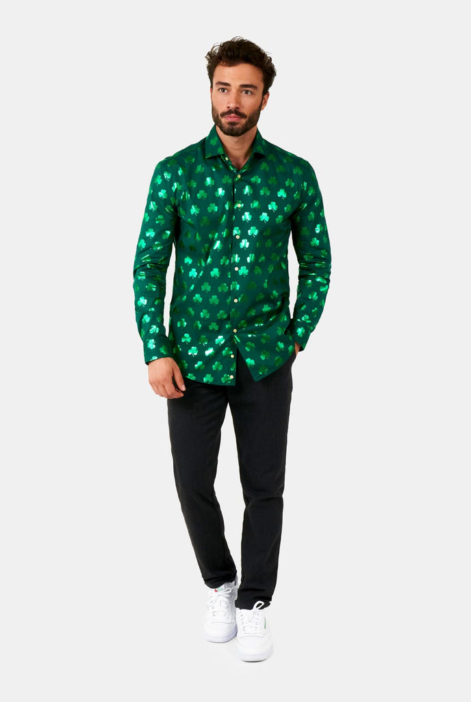 Man wearing Green St Patrick's Day shirt with green shiny clovers.