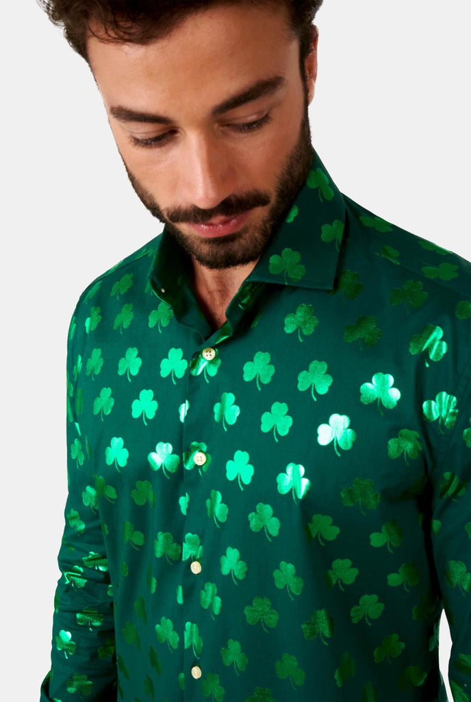 Man wearing Green St Patrick's Day shirt with green shiny clovers, close up