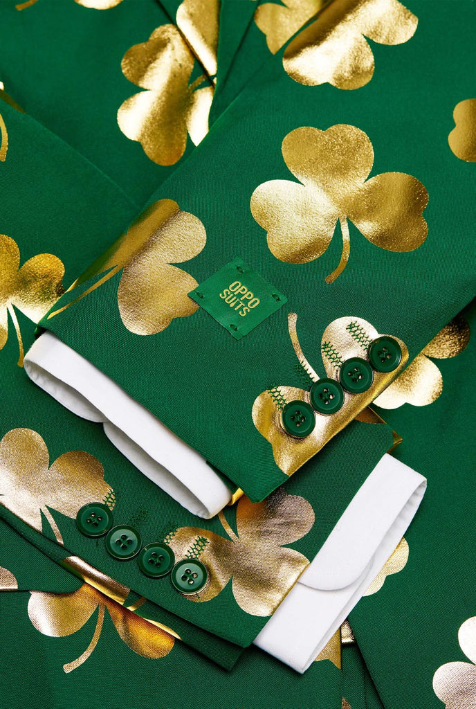 Man wearing green St Patrick's Day suit with golden clovers, close up.